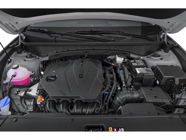 A Hyundai service technician in a navy and grey uniform uses a pneumatic impact wrench to work on a car tire.