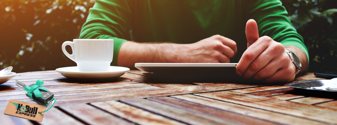 Person sitting at table with tablet with No Bull Express icon