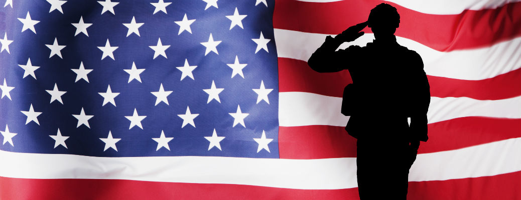 Silhouette of soldier in front of American flag