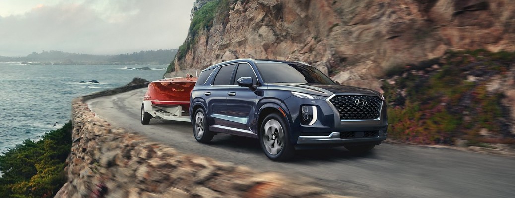 Blue 2021 Hyundai Palisade towing boat