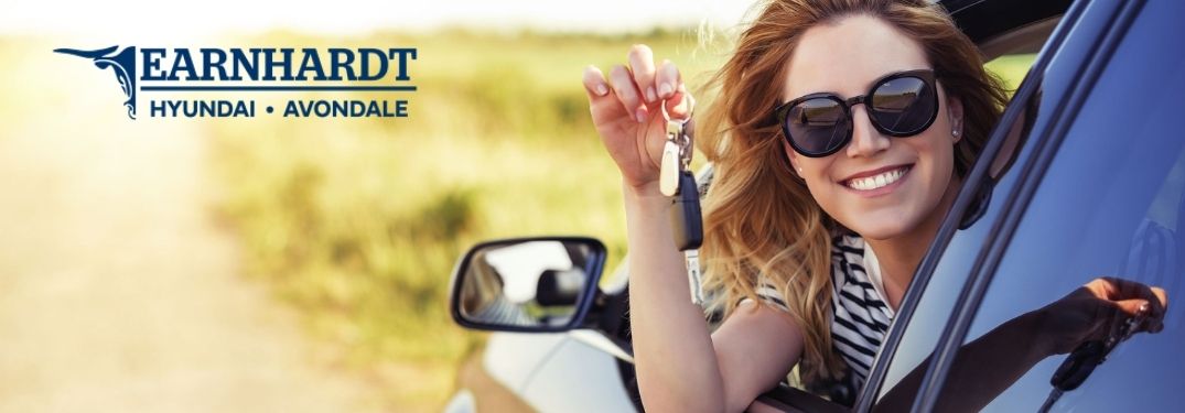 Smiling Woman in a New Car with Keys with Earnhardt Hyundai of Avondale Logo