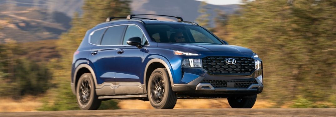 Blue 2022 Hyundai Santa Fe XRT Front and Side on Dirt Road
