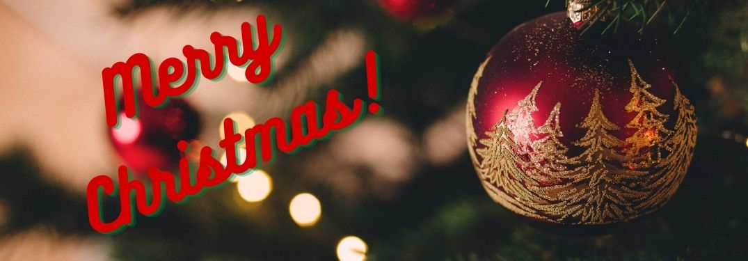 Red Ornament on a Christmas Tree with Red Merry Christmas Text