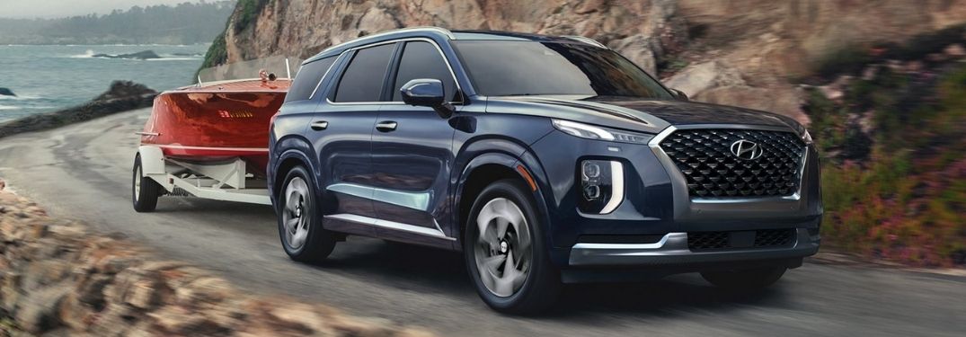 Blue 2022 Hyundai Palisade Towing a Red Boat