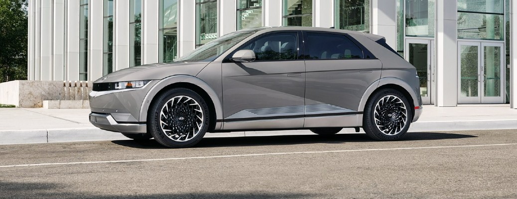 A silver 2022 Hyundai IONIQ 5 parked outside a nice office building. he New 2022 Hyundai IONIQ 5 Is Leading by Example.